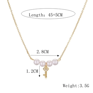Detail showing dimensions of golden pearl necklace with a key charm and length specs