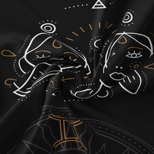 Close-up of Gemini constellation line art on black silk-textured bohemian tapestry
