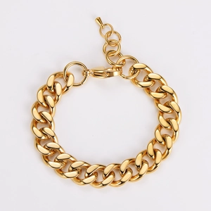 Detail of chunky gold chain bracelet with polished Cuban links and adjustable clasp