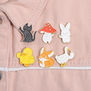 Detail of 6 creative animal enamel pins with middle finger gesture on pink denim jacket