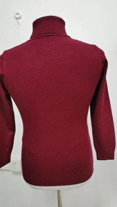Back view of slim fit burgundy turtleneck sweater featuring ribbed knit cuffs and collar