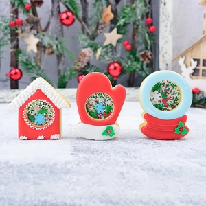 Christmas shaker cookie cutter set with gingerbread house, glove, and snow globe designs