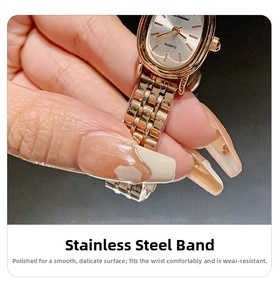 Macro detail of rose gold quartz watch featuring polished stainless steel mesh strap