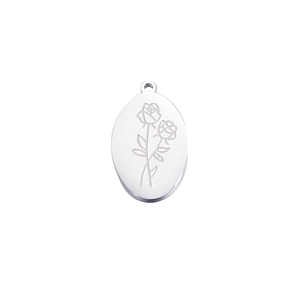 Detailed macro view of silver oval birthday necklace pendant with rose engraving