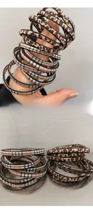 Detail showing elastic hair ties with leopard print and red plaid patterns on wrist