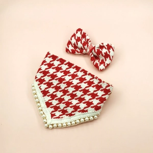 Detailed view of red houndstooth pet bandana and bowtie set with faux pearl trim