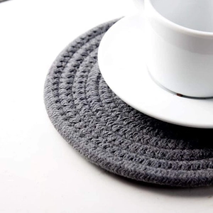 Close-up of grey woven cotton cup coaster showing handmade texture and heat resistance