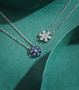 Detail of S925 sterling silver flower necklaces with white zircon and blue gemstones