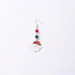 Macro shot of single Christmas earring with Santa pendant and colorful pearls