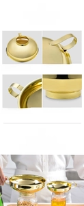 Close-up of golden stainless steel wide mouth funnels with mirror polished finish and handle