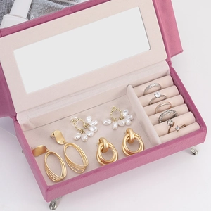 Pink velvet sofa style jewelry box with built-in mirror and earring storage slots