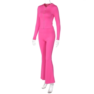 Detail of hot pink tracksuit featuring front zipper on hoodie and flare leg trousers style