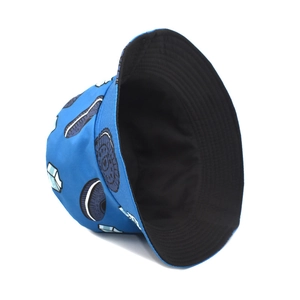 Detail of reversible bright blue bucket hat with cartoon milk and cookies pattern print