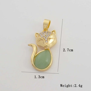 Detail view of fox pendant with green gemstone and zircon inlay measuring 2.7cm in height