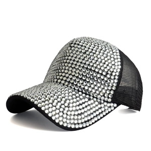 Close-up of sparkling rhinestones on black mesh baseball cap with silver crystal detail