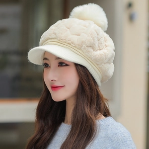 Women's cream plush winter hat featuring a stylish brim and a large fuzzy pom-pom