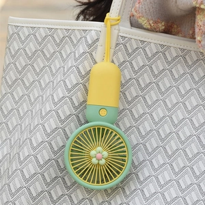 Mini ventilatore USB portatile giallo e verde con design floreale e cordino giallo