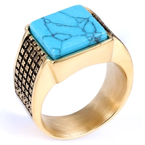 Macro shot of gold square turquoise ring with textured brushed metal side detailing