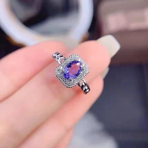 Elegant lavender purple oval gemstone ring with cluster diamonds and chain-style band
