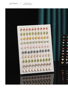 Detailed display of colorful alloy earrings on a gray velvet jewelry organizer board