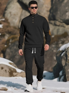 Detail of black knit tracksuit featuring textured diamond pattern and elbow patches