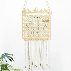Golden wall-mounted jewelry rack with bird silhouettes and seven butterfly hooks
