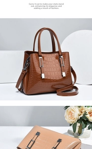 Détail d'un sac à main avec gaufrage crocodile, garniture en métal argenté et anses