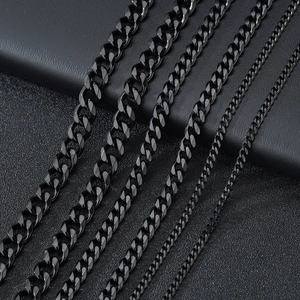 Multiple widths of stainless steel Cuban link necklaces shown in parallel on a dark surface
