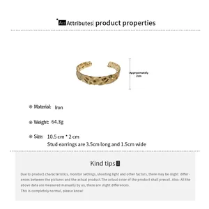 Detailed view of wide metallic hammered texture iron cuff bracelet in gold finish