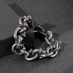 Industrial style nail link bracelet for men in vintage silver finish on black display stand