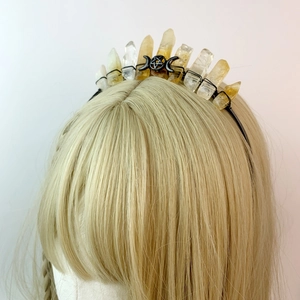 Macro detail of natural yellow crystal crown with black triple moon pentagram symbol