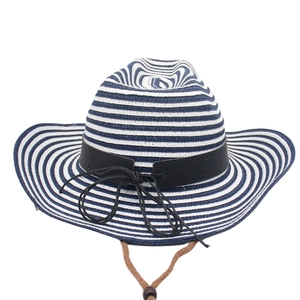 Detail of woven straw sun hat featuring blue stripes and adjustable brown chin strap
