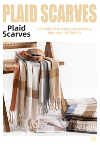 Detail of plaid scarf texture with long tassels draped over a rattan chair