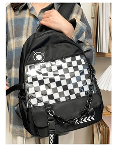 Close-up of black school backpack with checkered transparent window and chain detail
