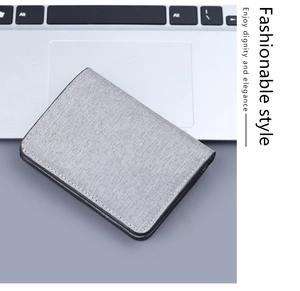 Detailed view of gray canvas wallet featuring premium texture and black oil-sealed edges