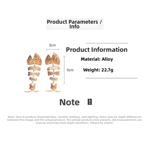 Detail view of large alloy fishbone earrings showing dimensions 3cm width and 9cm length