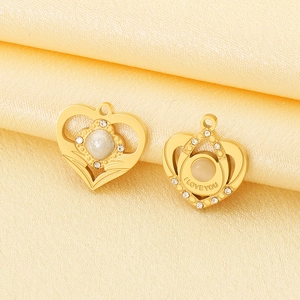 Detail of gold heart charms with white stones and I LOVE YOU engraving on silk