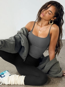 Detail of dark gray tank top with black yoga pants and gray fleece hoodie set