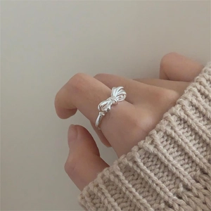 Detail of 925 sterling silver bow ring worn by a model in a minimalist Korean style