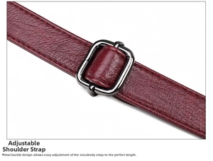 Detail view of burgundy leather bag strap with adjustable gunmetal buckle hardware