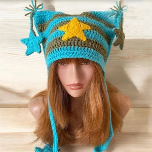 Detail of striped crochet cat ear beanie featuring yellow star pendants and tassels