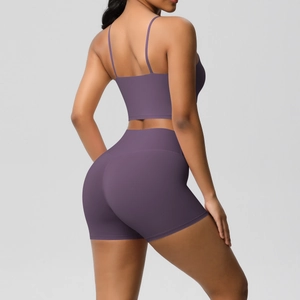 Detail of deep purple high-waist yoga shorts and strappy back sports bra set for fitness