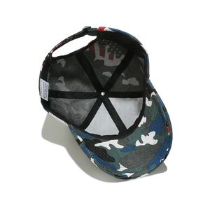 Detail view of camouflage baseball cap interior with 100% polyester fabric and metal buckle