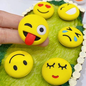 Close-up of cute yellow emoji decorative accessories featuring various facial expressions