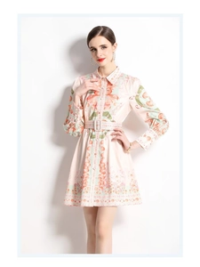 Detail of floral printed mini dress with belt and elegant lantern sleeve pleats
