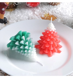 Detailed view of red and green cedar tree scented candles with white snowy wax tips