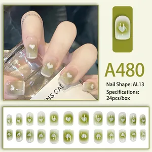 Fresh green gradient press-on nails with white heart motif and 24-piece full set display