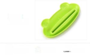 Close-up of green bear-shaped tube squeezer showing the narrow slot for toothpaste