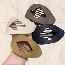 Four vintage acrylic hair clips with minimalist hollow geometric design for women