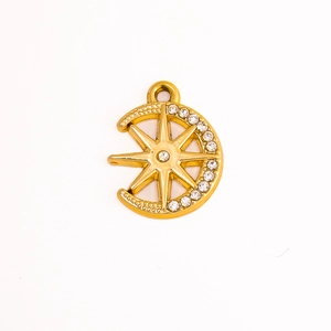 Macro detail of a golden crescent moon and star pendant with sparkling zircon stones